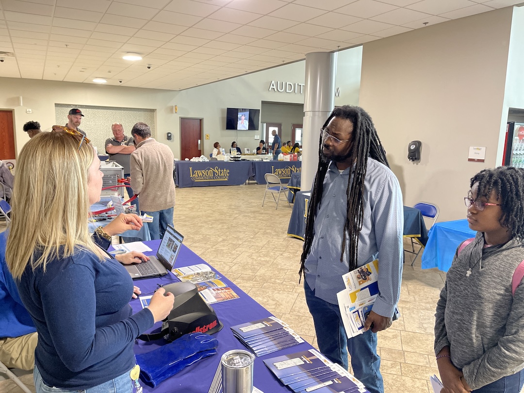 father and son talk with welding instructor about college