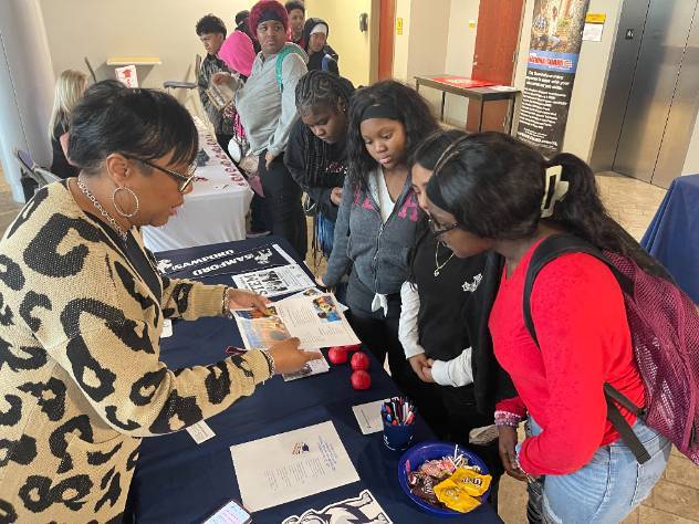 Ms. Debro, a STEM recruiter from Samford University talks with students