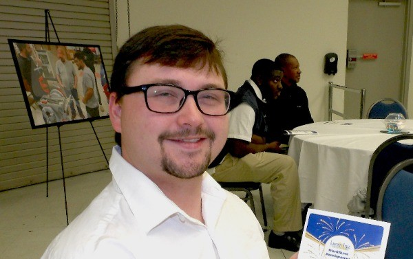 Adam Qualls smiles at camera upon completion of natural gas worker program